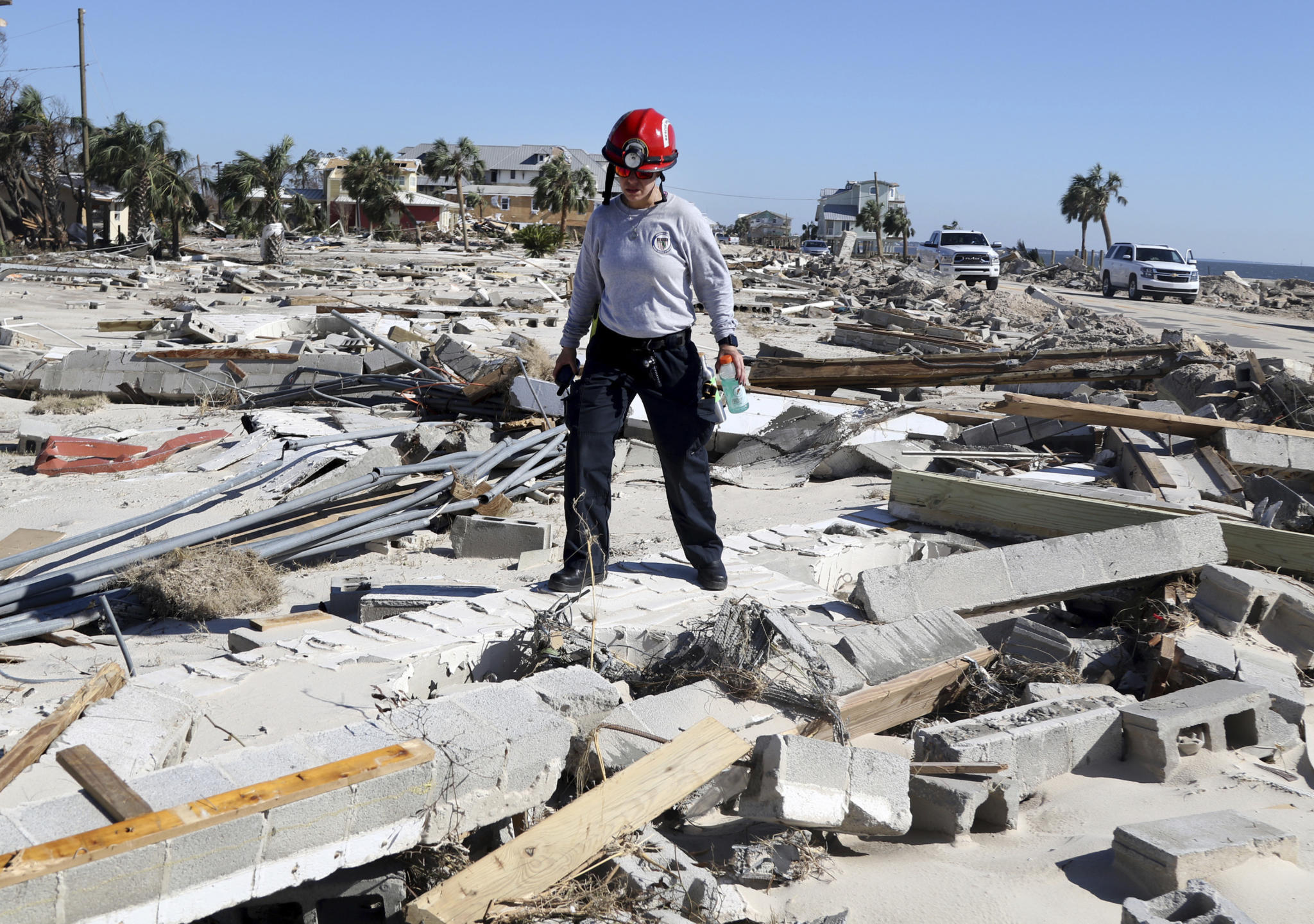 A Miami firefighter searches for survivors Friday, Oct. 12, 2018 in Mexico Beach, Fla. Mexico Beach, Florida was devastated when Hurricane Michael made landfall on Wednesday in the Florida Panhandle. (Douglas R. Clifford/Tampa Bay Times via AP)