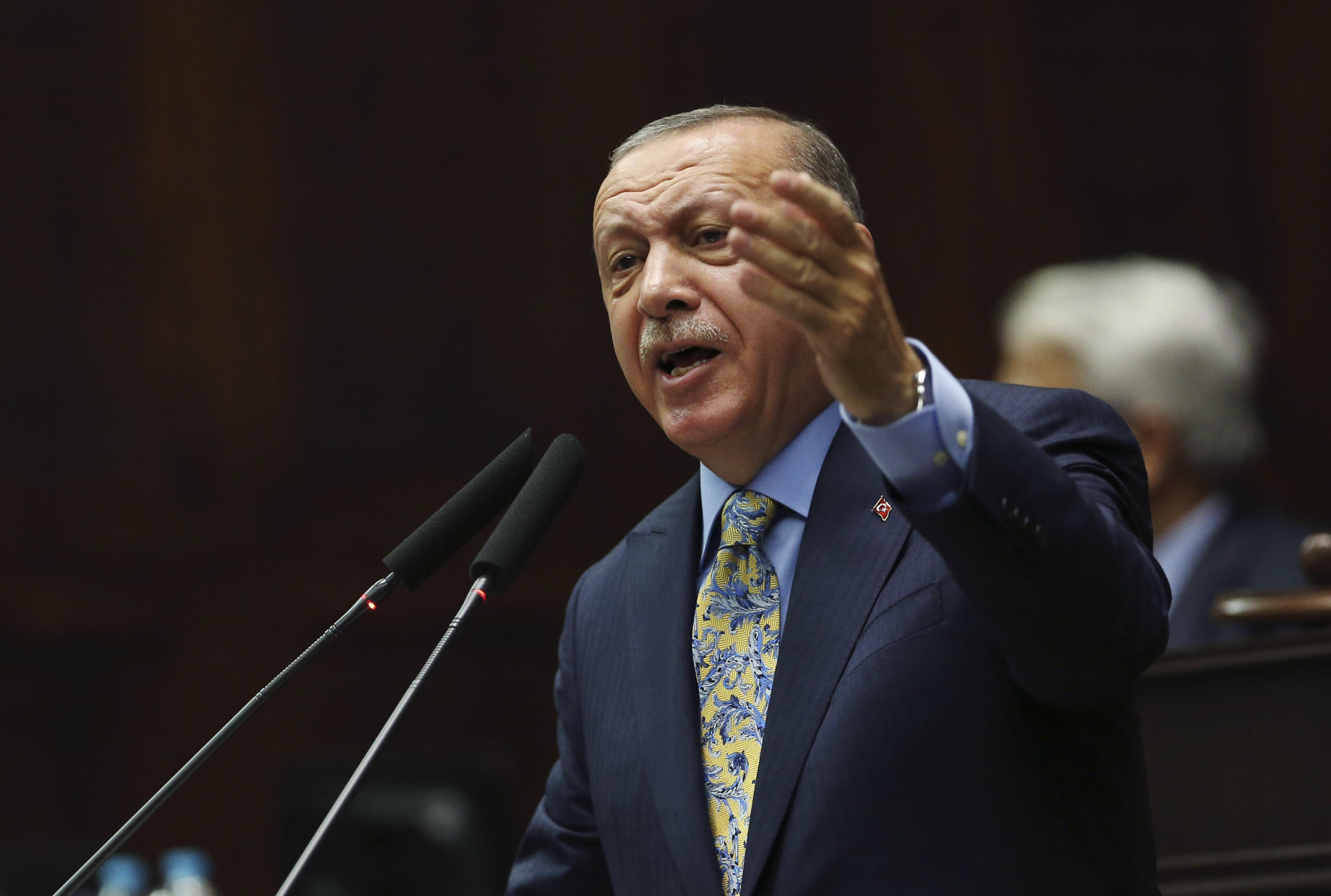 Turkey's President Recep Tayyip Erdogan gestures as he addresses members of his ruling Justice and Development Party (AKP), at the parliament in Ankara, Turkey, Tuesday, Oct. 23, 2018. Turkey's president says Saudi officials started planning to murder Saudi writer Jamal Khashoggi days before his death in Saudi Arabia's Istanbul consulate. (AP Photo/Ali Unal)