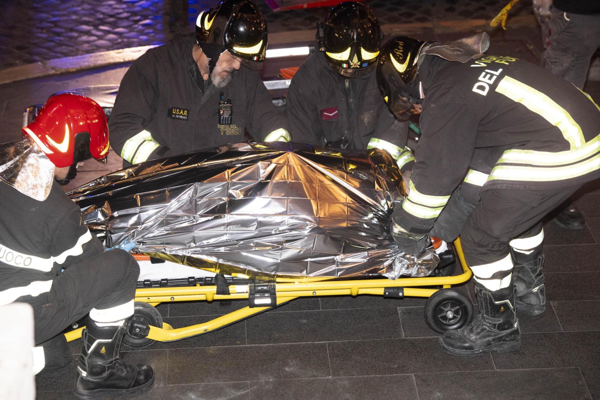 Firefighters evacuate a person who was wounded after an escalator at the "Repubblica" subway station in Rome, started running much too fast before crashing, Tuesday, Oct. 23, 2018. According to first reports many of the people wounded in the accident were fans of CSKA Moscow, who were in Rome for tonight's Champions League match with Roma. (Claudio Peri/ANSA via AP)